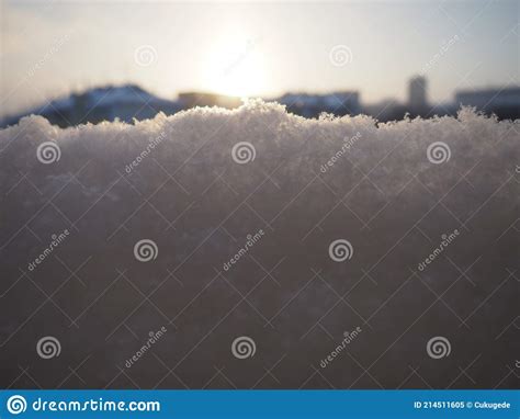 Sunset In The Winter Snow And Snowflakes City Skyline Houses And