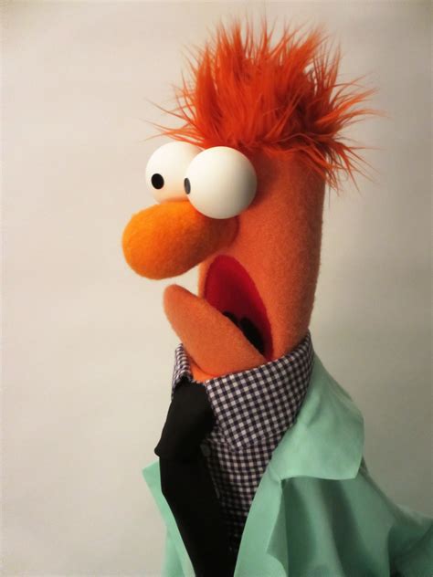 An Orange Bird With Red Hair Wearing A Green Shirt And Black Tie