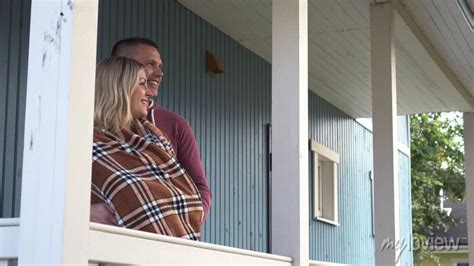 Happy Young Man Hugging His Pregnant Girlfriend In A Blanket • Wall