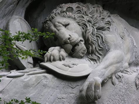 Symbolic Lion Sculpture Carved Laying In A Cliff