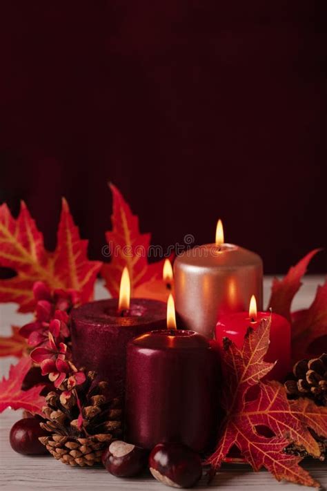 Autumn Still Life Candles Leaves And Cones On The Background Of