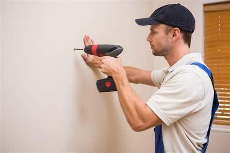 Premium Photo Construction Worker Drilling Hole In Wall