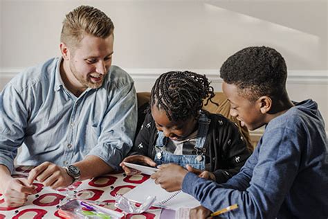 Dad Helping Son And Daughter With Homework First4adoption