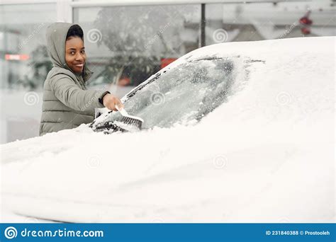 Woman Removing Snow From Car Windshield Stock Photo Image Of Frost