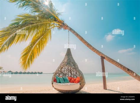 Beautiful Tropical Maldives Beach Under Cloudy Sky With Swings On
