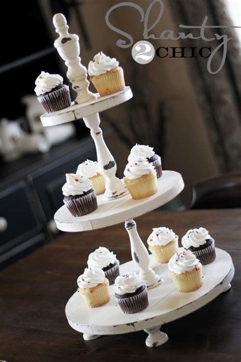 Three Tiered Cupcake Stand With White Frosting And Chocolate Cupcakes