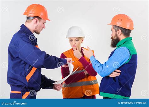 Men In Hard Hats Uniform And Woman Team Of Architects Stock Photo