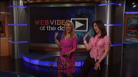 Two Women Are Talking On The Set Of Webviders Of The Day With One Holding Her Hand Up