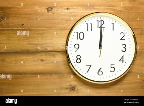 Wall Clock On The Wooden Wall At Time 12am Or 12pm Stock Photo