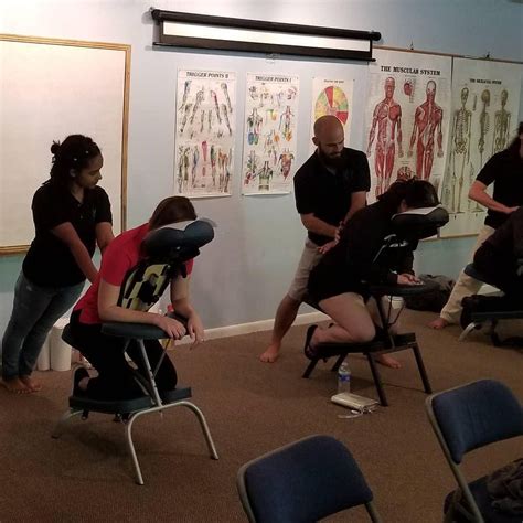 “classmates doing chair massage at the open house ” yogaclearing january class photo of the