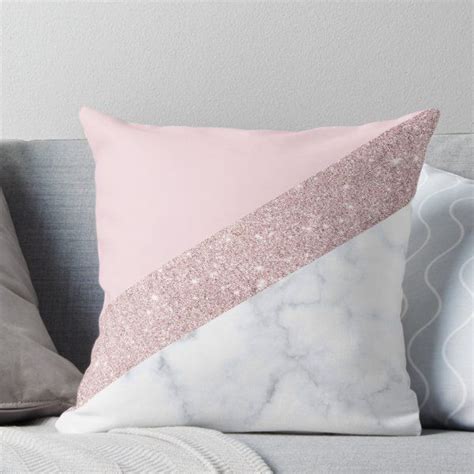 A Pink And White Pillow Sitting On Top Of A Couch