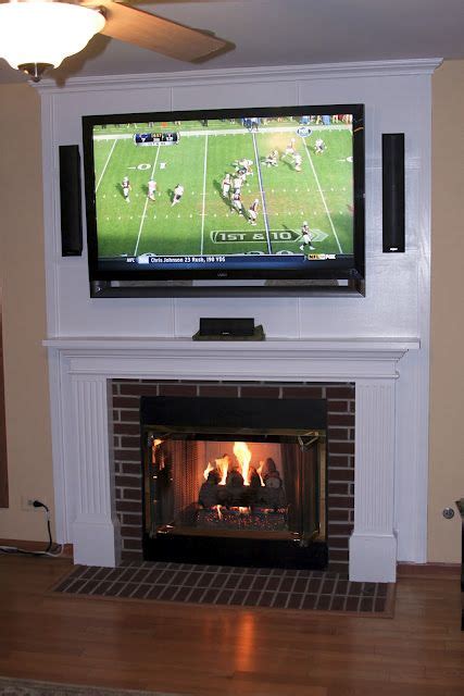 A Flat Screen Tv Mounted Above A Fire Place