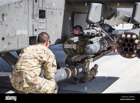 Us Army Ah 64e Apache Helicopter Ground Crew Members Assigned To Task