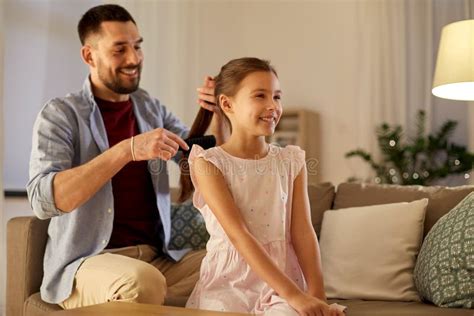 father brushing daughter hair at home stock image image of leisure hair 136874427