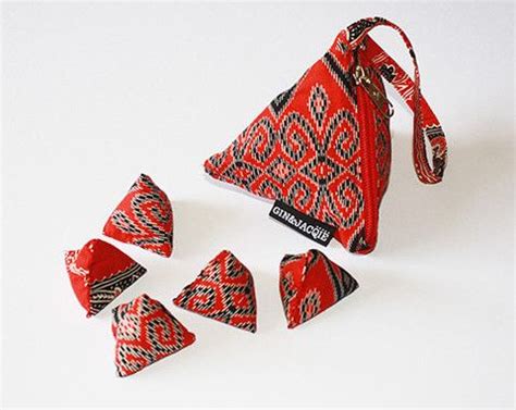 Today, many children, and adults, play the game using little cloth bags filled with beans, rice, fish gravel, etc. BATU SEREMBAN, children's game also known as "jacks". # ...