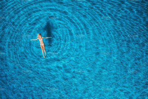 Aerial View Of Swimming Woman In Mediterranean Sea At Sunset Featuring
