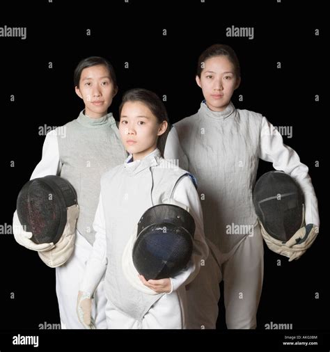 Portrait Of Three Female Fencers Holding Fencing Masks Stock Photo Alamy