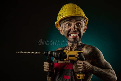 A Man Miner In A Worker S Clothes And A Helmet Dirty In Soot With A