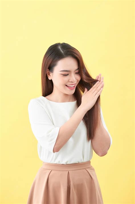 Premium Photo Beauty Woman Touch Her Long Hair Isolated On Yellow Background Asian Beauty