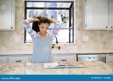 Young Housewife Is Tying Her Hair Before Cooking Stock Photo Image Of