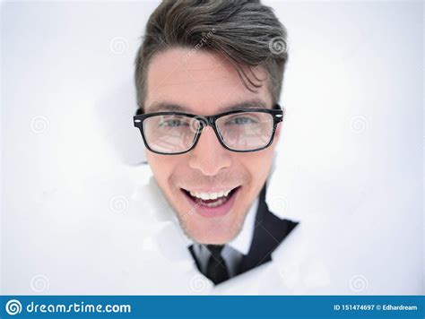 Young Businessman Breaking Through A White Paper Wall Stock Image