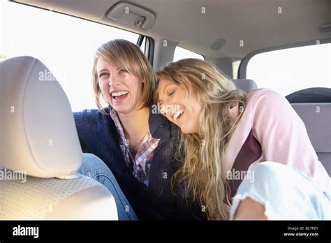 Two Women In Backseat Of Car Stock Photo Alamy