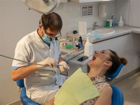 Dentist S Office The Doctor Treats The Teeth Of An Adult Woman Stock