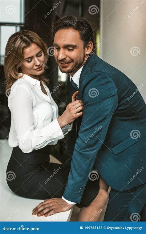 Smiling Couple Flirting At Workplace Intimate Relationship Or Passionate Affair In Office Stock