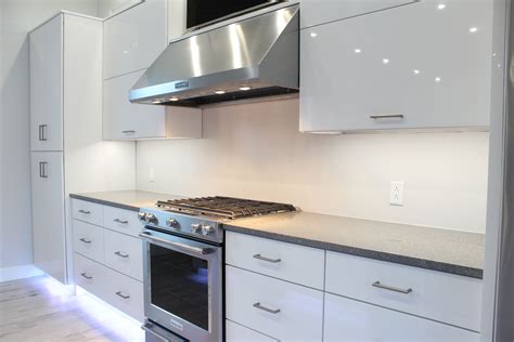 Glossy White Contemporary Cabinetry With Quartz Countertops And Led