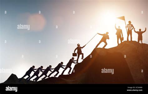 Concept Of Teamwork With Team Climbing Mountain Stock Photo Alamy