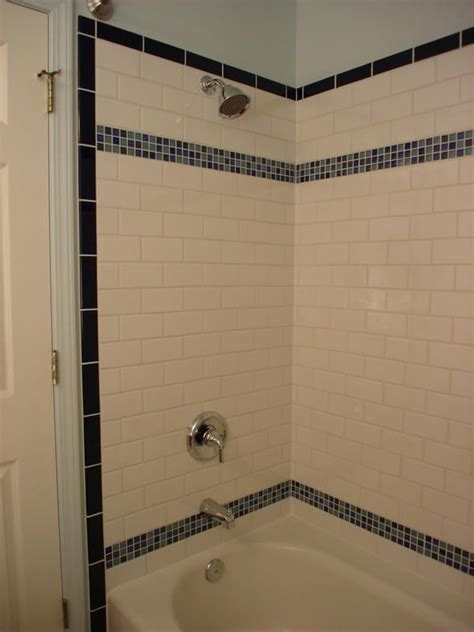 Amazing gallery of interior design and decorating ideas of decorative tile shower in bathrooms, laundry/mudrooms by elite interior designers. Vertical shower border with white subway tile | Kids bath ...