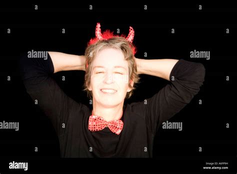 Woman Wearing Devil Horns Laughing Stock Photo Alamy
