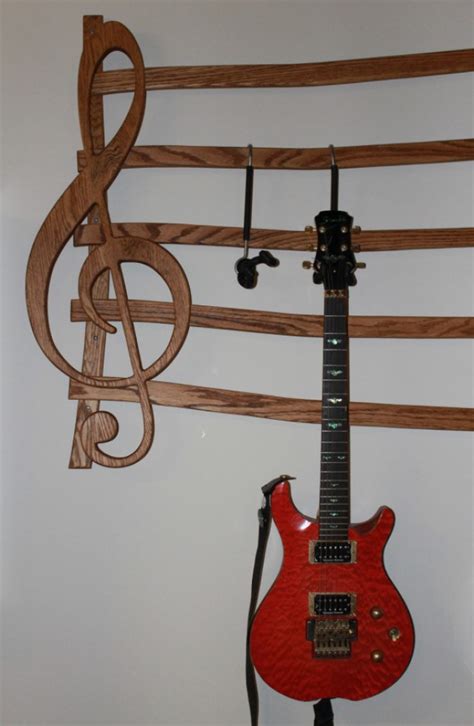 Here are some ideas for guitar mounting hooks. Wall Mounted Multi-Guitar wall hanger | aftcra