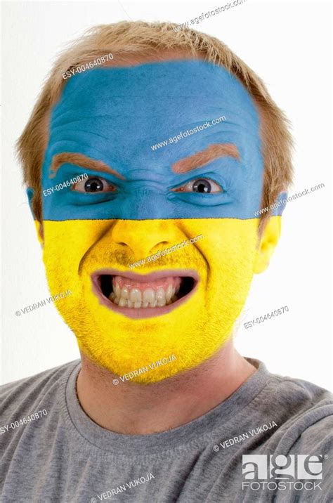 Face Of Crazy Angry Man Painted In Colors Of Ukraine Flag Stock Photo