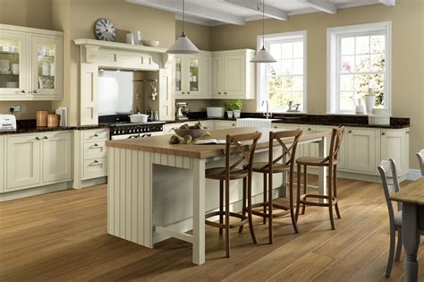 Design ideas for a traditional kitchen/diner in london with a submerged sink, shaker cabinets, blue cabinets, black appliances, an island, brown floors, white worktops and dark hardwood flooring. Cream Oak Painted | Kitchen design, Kitchen table small ...