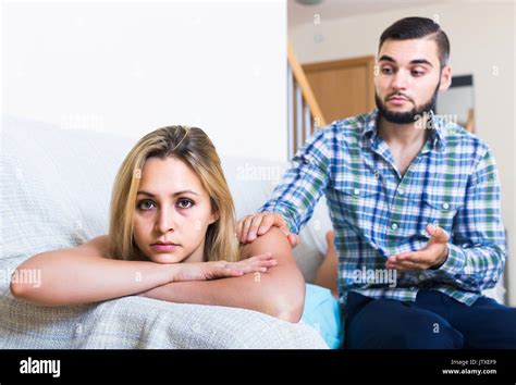 Sad American Adult Asking Offended Partner For Forgiveness At Home