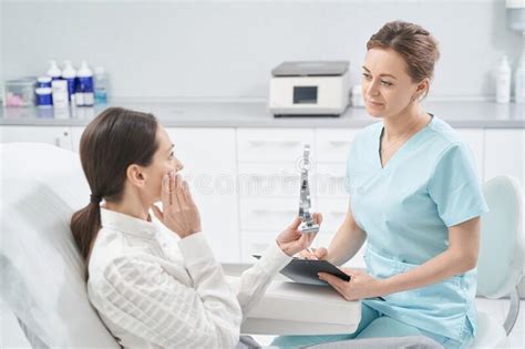 Woman Having Consultation With Doctor In Cosmetology Clinic Stock Photo