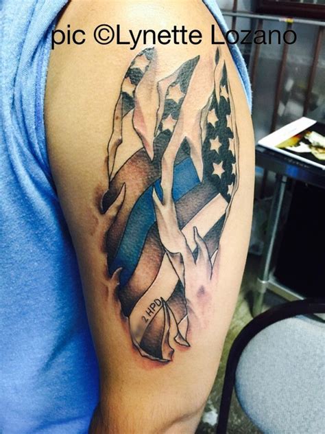 Tiny tattoo of the american flag placed on a woman's back side. Ripped skin tattoo, Tattoos, Police tattoo