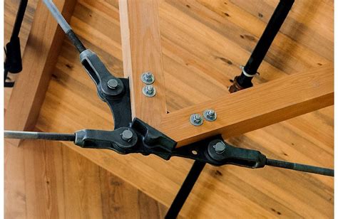 An Overhead View Of A Wooden Floor With Metal Brackets And Screws On