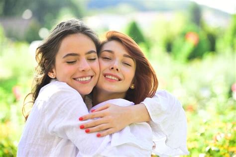Premium Photo Two Women Friends Laughing And Hugging Outdoors Girls Love