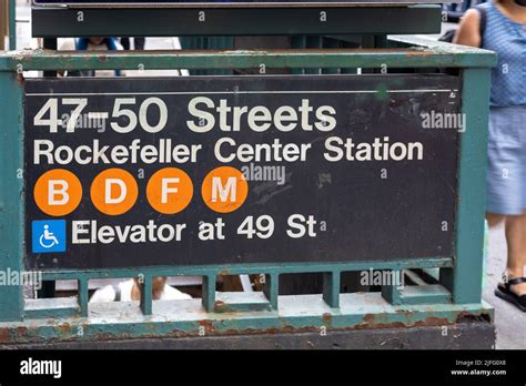 A Rockefeller Center Subway Station Sign Board On A Metal Fence At The