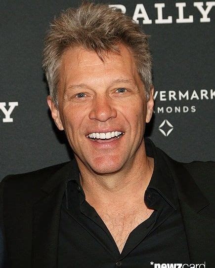 a man with grey hair smiling at the camera