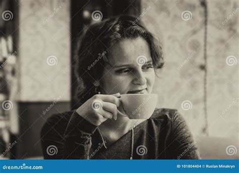 Beautiful Girl With A Cup Of Coffee In A Cafe With A Touch Of S Stock