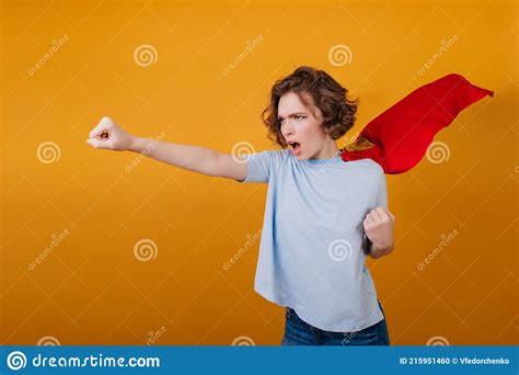 Confident Short Haired Girl Posing In Red Superhero Cloak Studio Shot