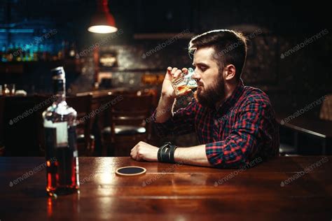 Man Sitting At The Bar And Drink Strong Alcohol By Nomadsoul1鈥檚 Photos