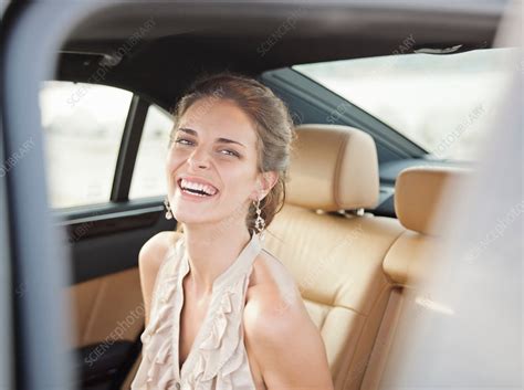 Smiling Woman Sitting In Backseat Of Car Stock Image F