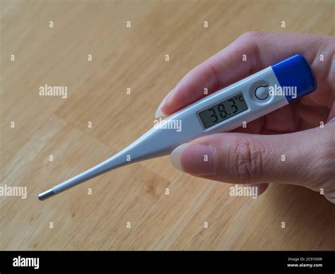 Woman Hand Holding Electric Clinical Thermometer Showing High Fever