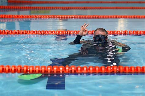 Premium Photo Man Teaches Diving In The Pool Swim Coach