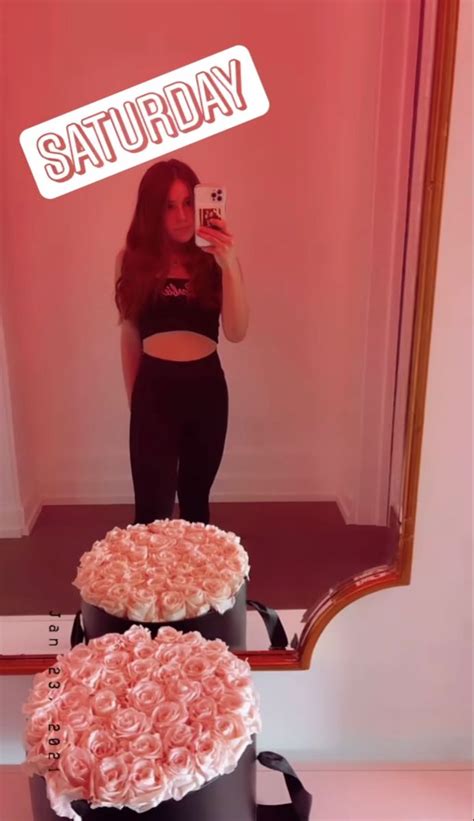a woman taking a selfie in front of a mirror with three cakes on it