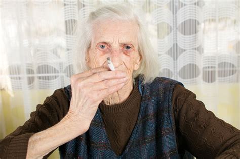 Grandma Smoking A Cigarette At Home Stock Photo Download Image Now